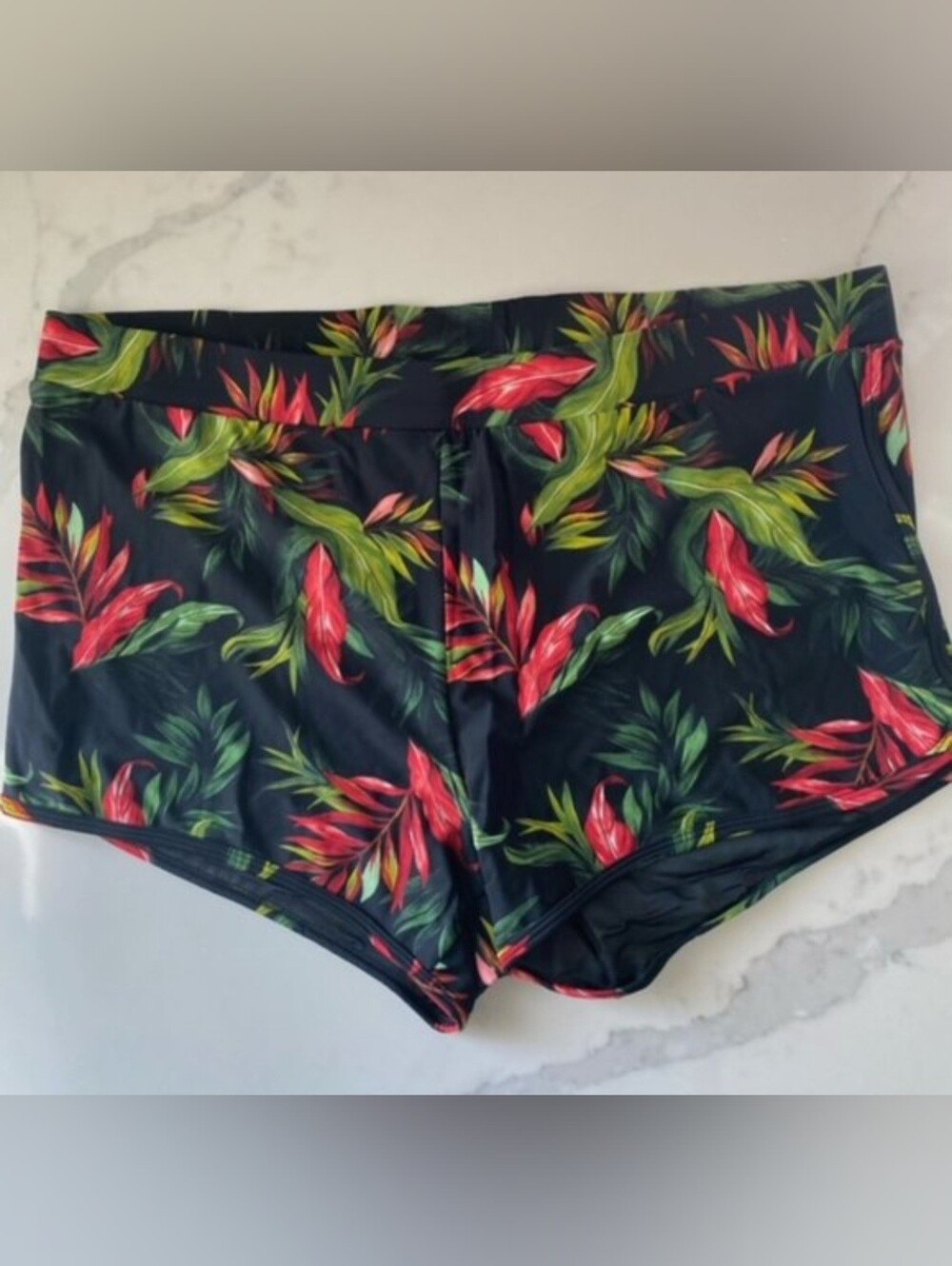 Torrid black tropical print dolphin hem swim shorts. Size 1